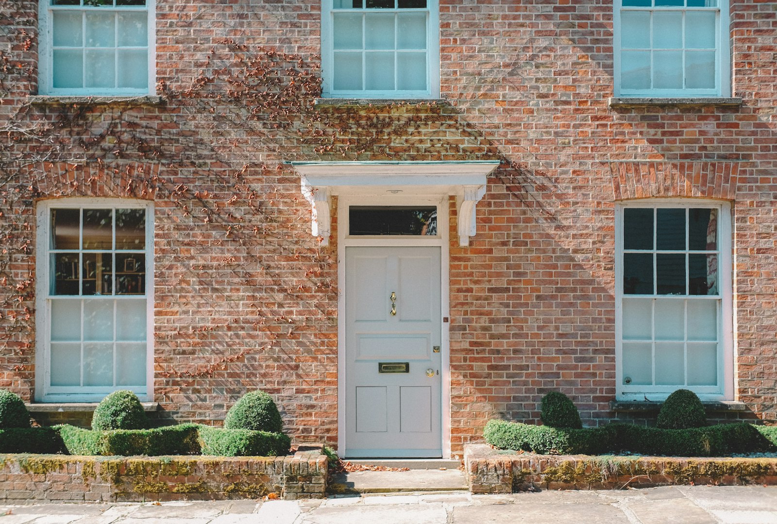 A red-brick house with a white front door